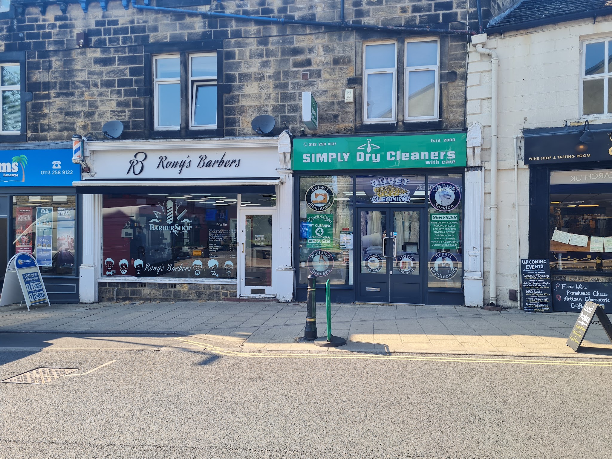 Rony's Barbers shopfront with its white fascia and barber pole on Town Street